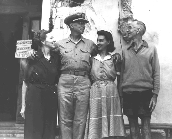 Lt. Commander Fred Worcester poses with his sister Alice and her recently liberated family.